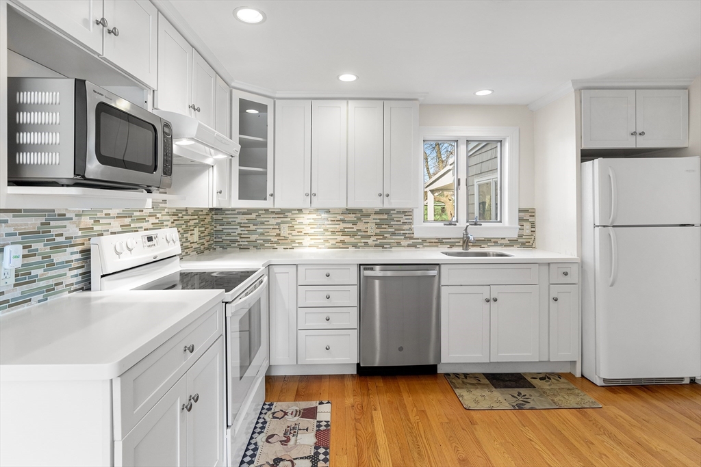 10 Ellison Road Lexington, MA 02421 - Photo 5 of 35 a kitchen with white cabinets and appliances
