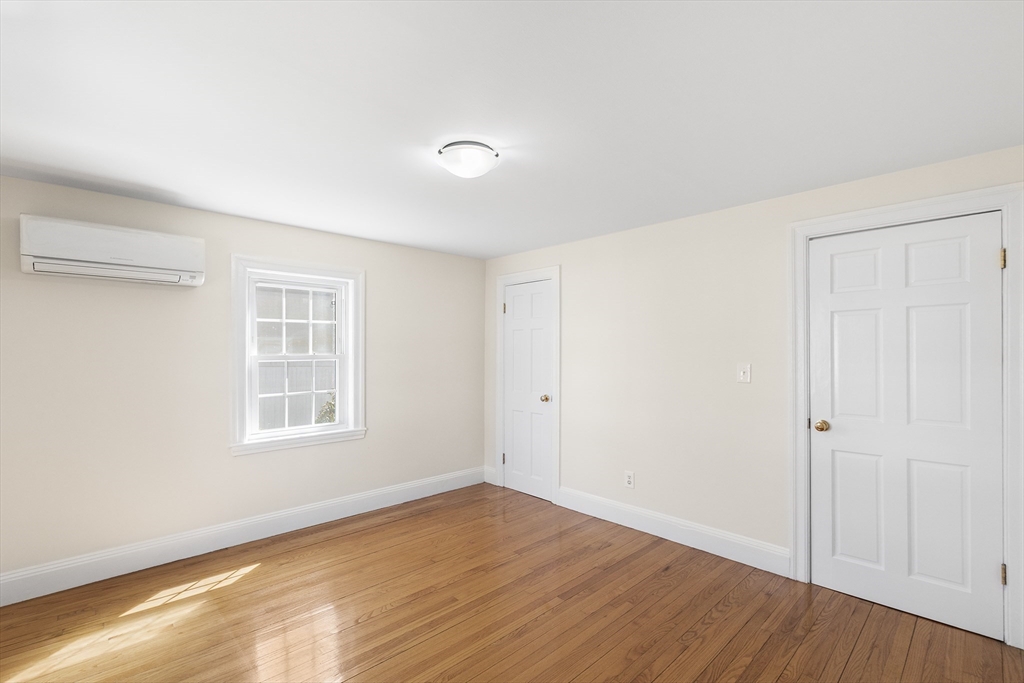 10 Ellison Road Lexington, MA 02421 - Photo 7 of 35 an empty room with wooden floor and windows