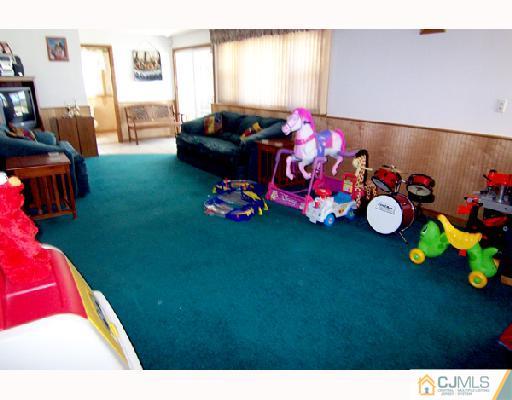 33 Highland Road Colonia, NJ 07067 - Photo 5 of 10 a bedroom with furniture and a flat screen tv