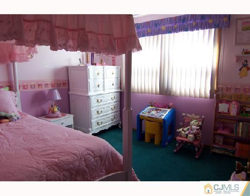 33 Highland Road Colonia, NJ 07067 - Photo 8 of 10 a bed room with a bed and a television