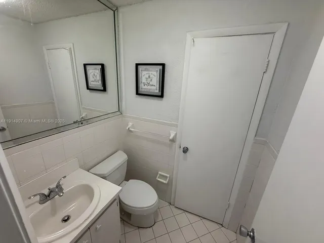 a bathroom with a sink toilet and a mirror