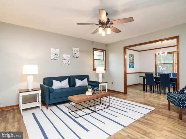 a living room with furniture a two lamp wooden floor and a rug
