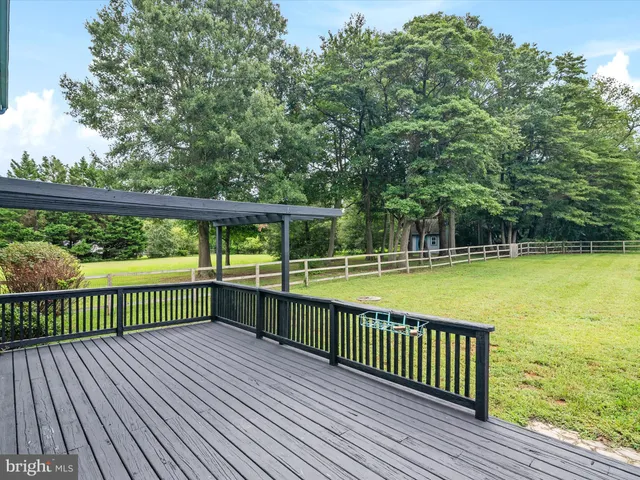 a view of a wooden deck with a yard