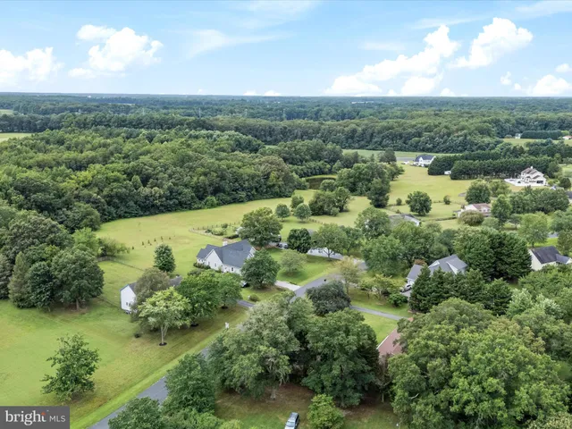 an aerial view of a houses with a yard
