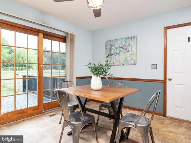 a dining room with furniture and wooden floor