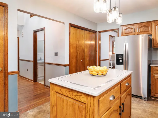a kitchen with a table chairs and refrigerator