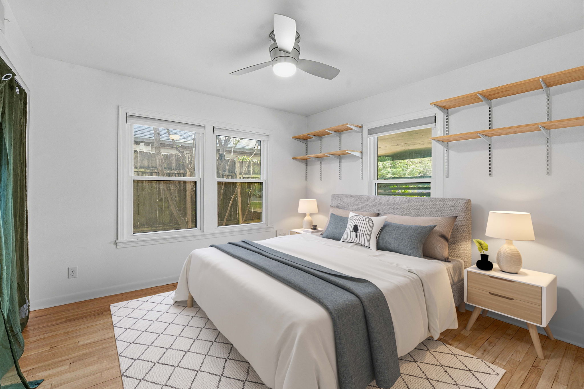 900 Stark Street Austin, TX 78756 - Photo 18 of 25 Comfortable bedroom with warm hardwood flooring and ample natural light from multiple windows.