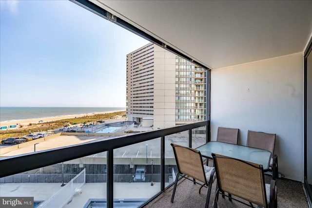a view of a room with a table and chairs