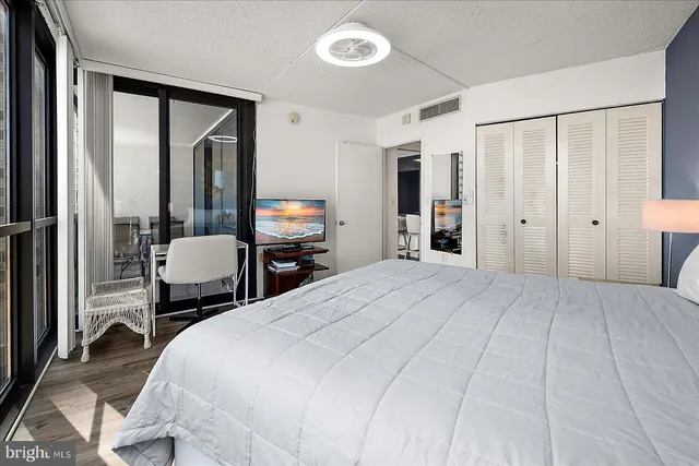 a bedroom with a bed and a large mirror