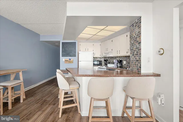 a white refrigerator freezer sitting inside of a kitchen