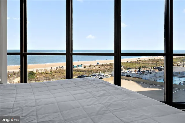 a view of an empty room with large windows