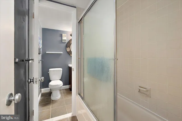 a bathroom with a toilet and a shower