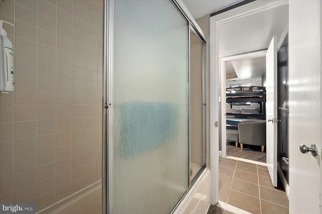 a bathroom with a glass shower door and a sink