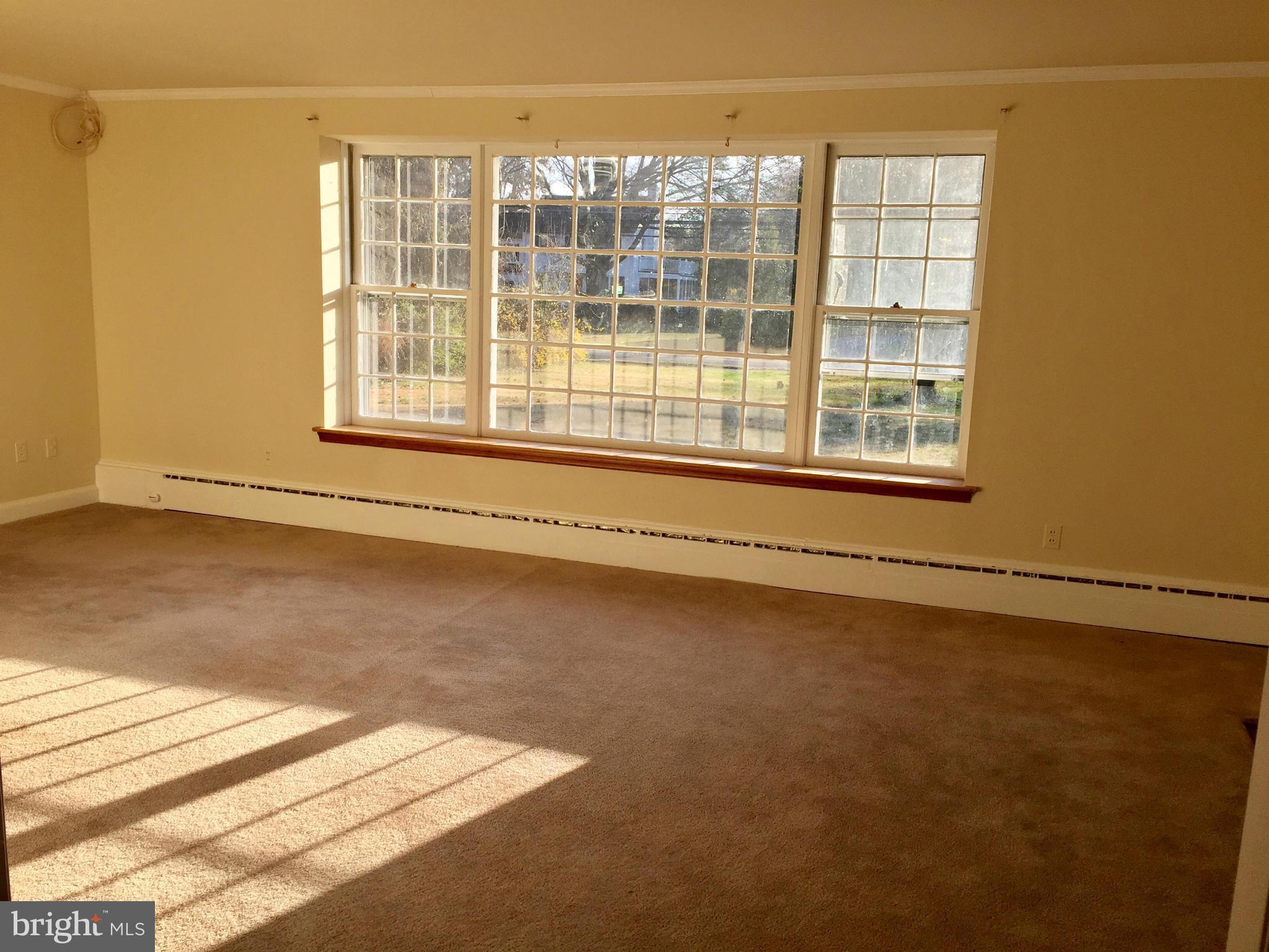 9424 Seven Locks Road Bethesda, MD 20817 - Photo 4 of 30 an empty room with wooden floor and windows