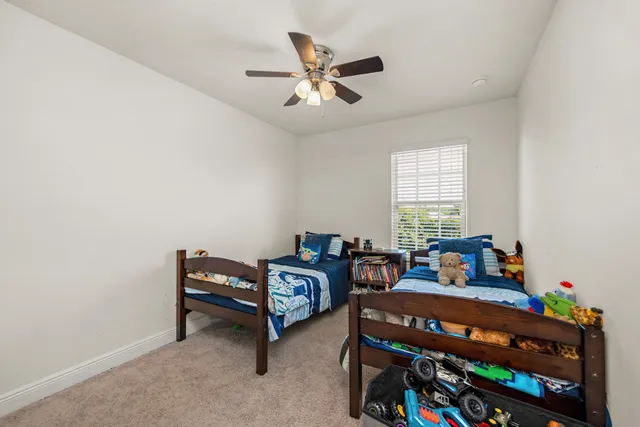 a bedroom with two beds and window