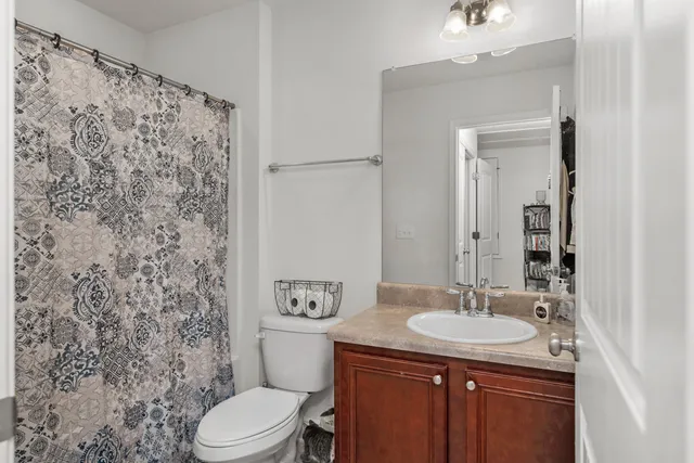 a bathroom with a sink toilet and a mirror