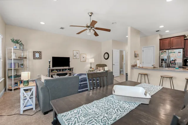 a living room with furniture a rug and a flat screen tv