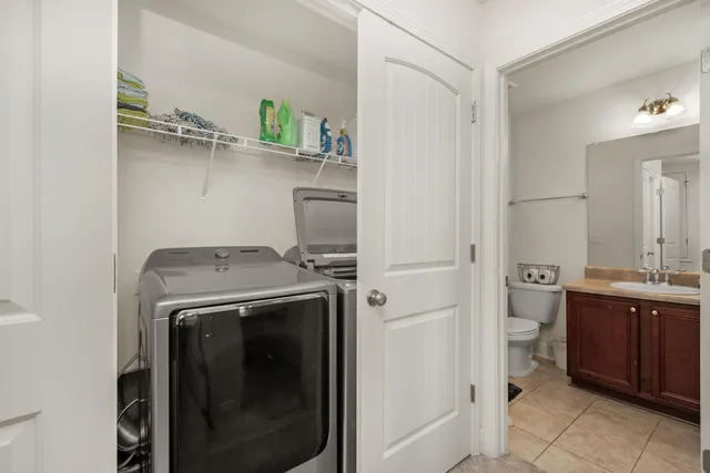 a utility room with cabinets washer and dryer