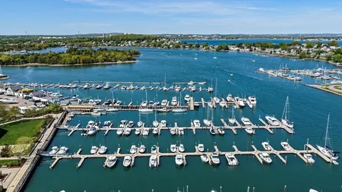 an aerial view of a city with lots of residential buildings lake and ocean view