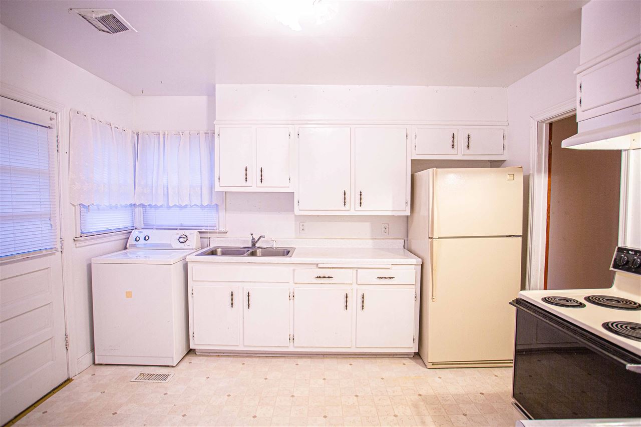 225 Anthony Street Ripley, TN 38063 - Photo 5 of 19 a kitchen with a white stove top oven and refrigerator