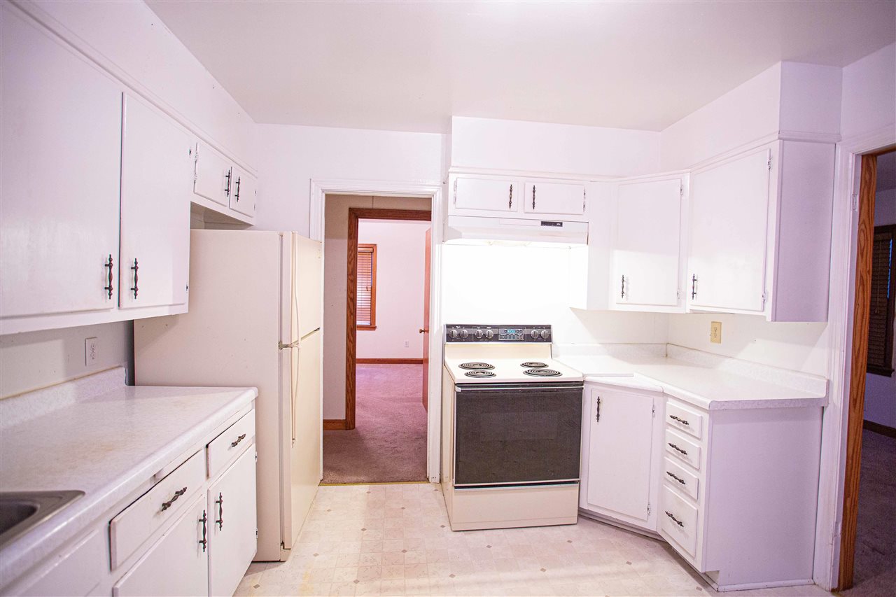 225 Anthony Street Ripley, TN 38063 - Photo 7 of 19 a kitchen with a sink stove and refrigerator