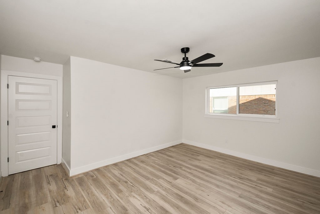 6106 Rutherglenn Drive Houston, TX 77096 - Photo 34 of 41 Bright and spacious additional bedroom with updated flooring and modern ceiling fan.