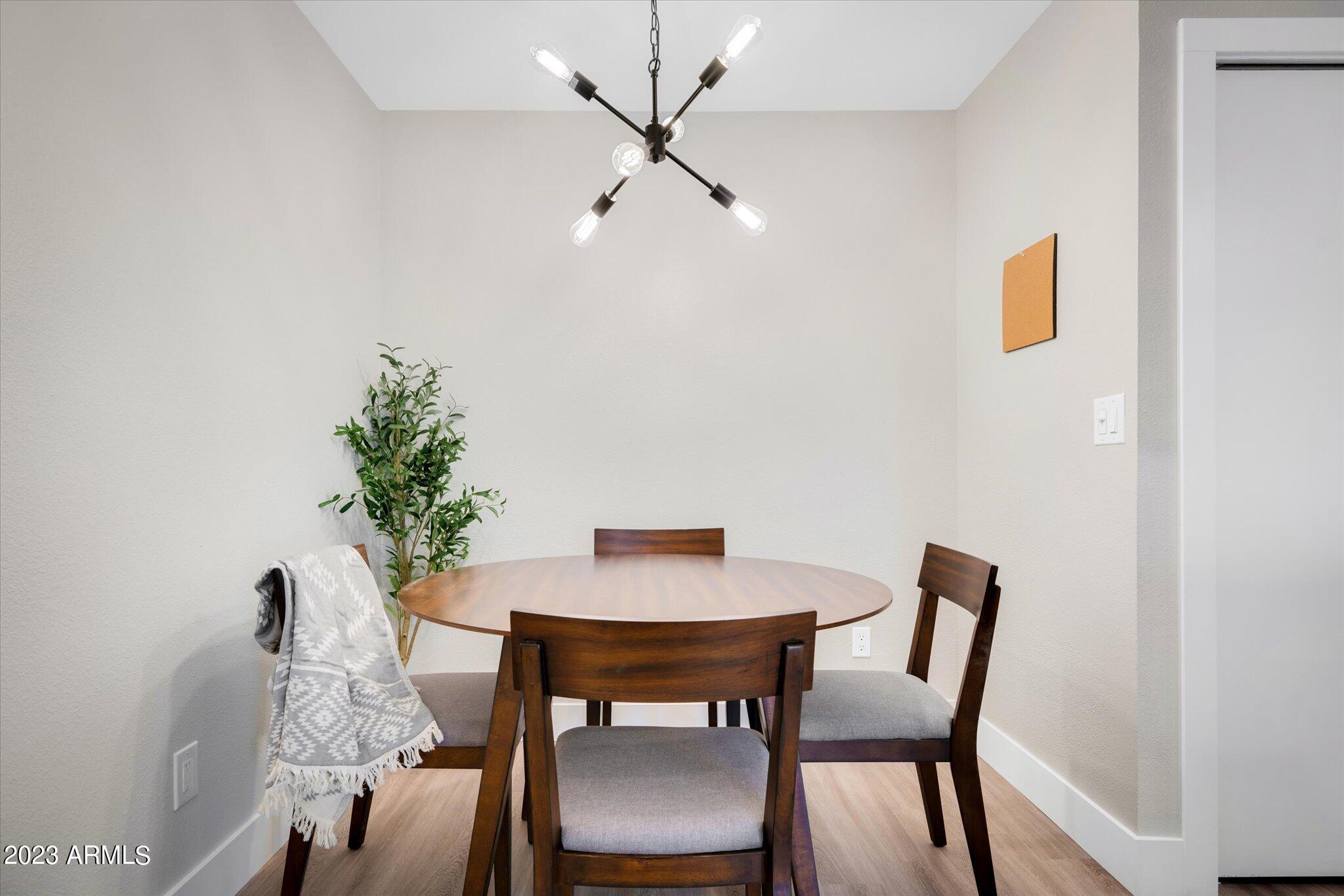 533 West Guadalupe Road, Unit 1024 Mesa, AZ 85210 - Photo 16 of 60 a view of a dining room with furniture and wooden floor