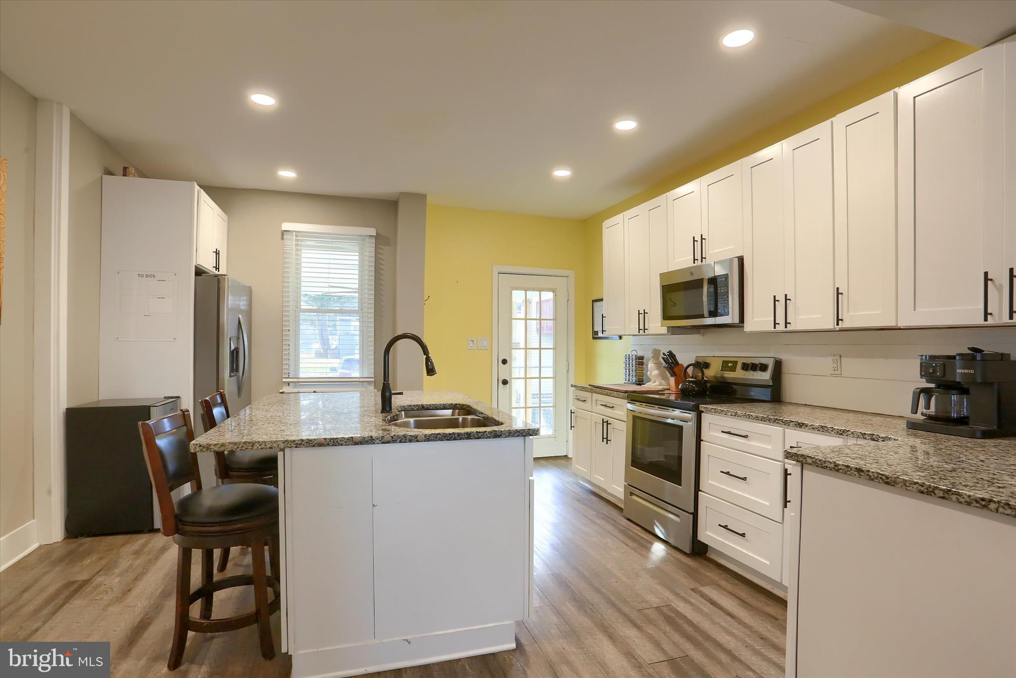 1544 Lafayette Street Lebanon, PA 17042 - Photo 13 of 49 a kitchen with stainless steel appliances granite countertop a sink a stove a refrigerator cabinets and chairs