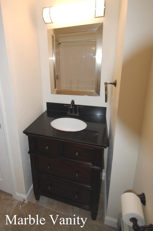 16 Hartness Road, Unit B Sutton, MA 01590 - Photo 11 of 16 a bathroom with a sink and a mirror