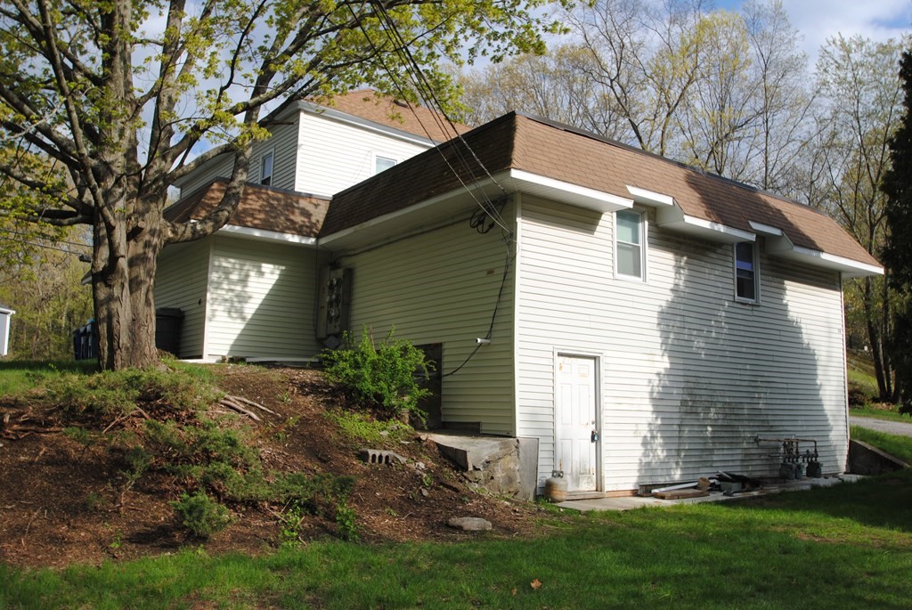 16 Hartness Road, Unit B Sutton, MA 01590 - Photo 16 of 16 a view of a house with a yard and a tree