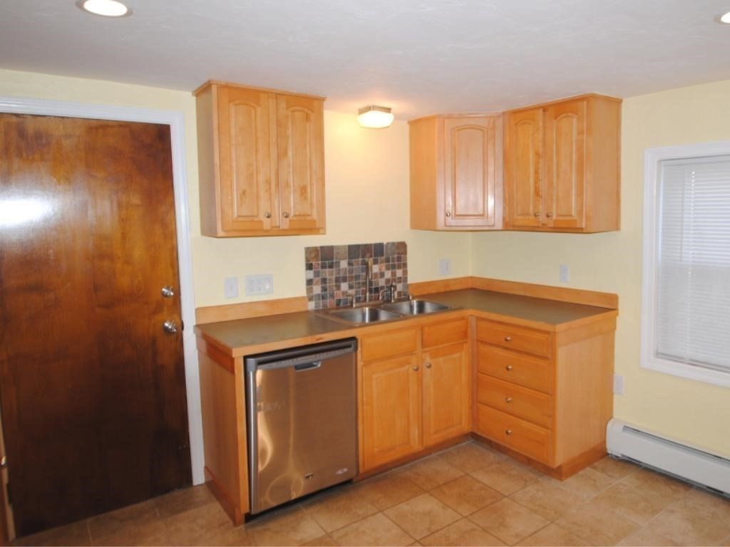 16 Hartness Road, Unit B Sutton, MA 01590 - Photo 2 of 16 a kitchen with stainless steel appliances granite countertop a sink and a refrigerator