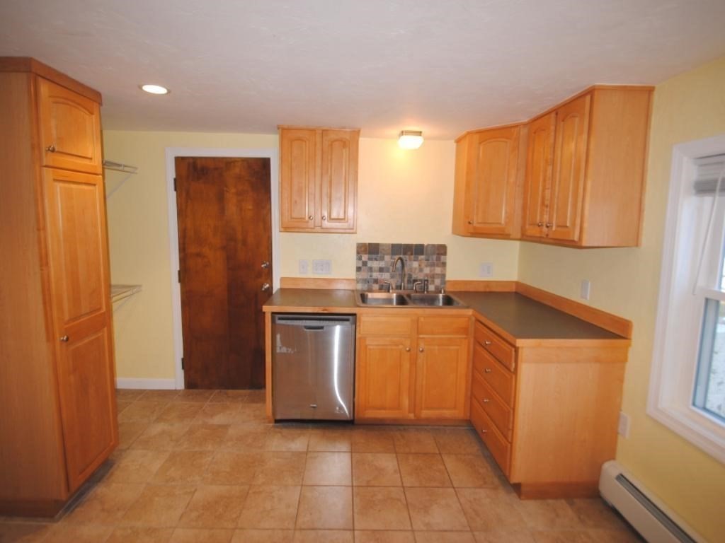 16 Hartness Road, Unit B Sutton, MA 01590 - Photo 5 of 16 a kitchen with stainless steel appliances granite countertop a refrigerator a sink a stove and oven