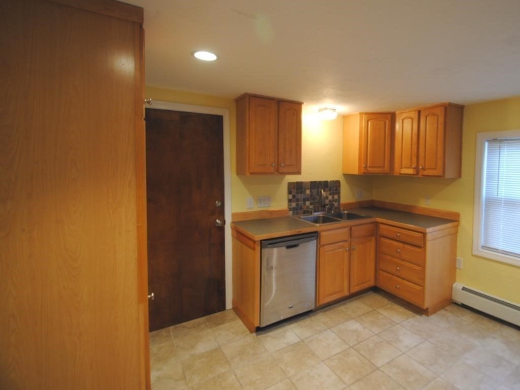 16 Hartness Road, Unit B Sutton, MA 01590 - Photo 7 of 16 a kitchen with granite countertop a sink and a stove top oven