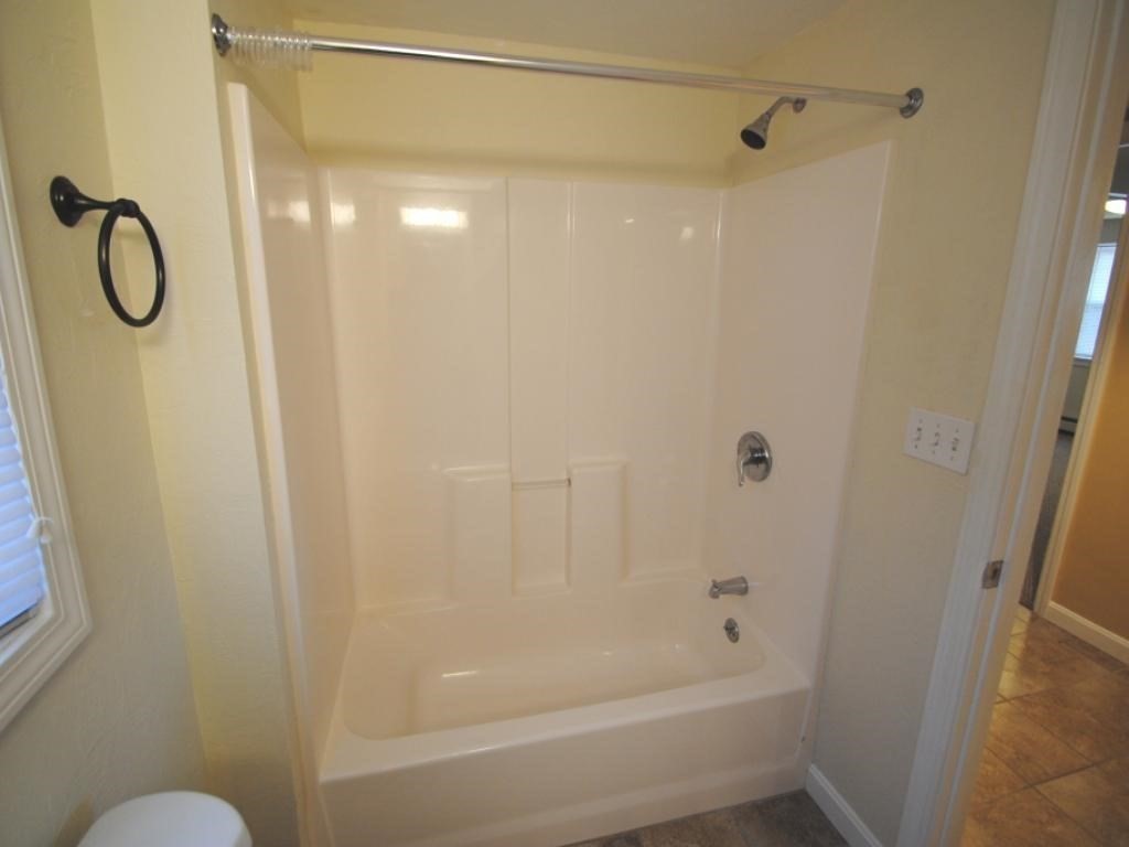 16 Hartness Road, Unit B Sutton, MA 01590 - Photo 9 of 16 a bathroom with a glass shower door