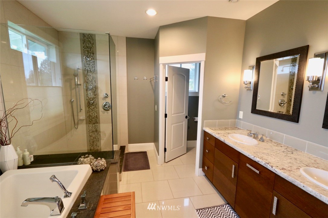 530 Briar Road Bellingham, WA 98225 - Photo 13 of 40 a spacious bathroom with a granite countertop tub sink and mirror