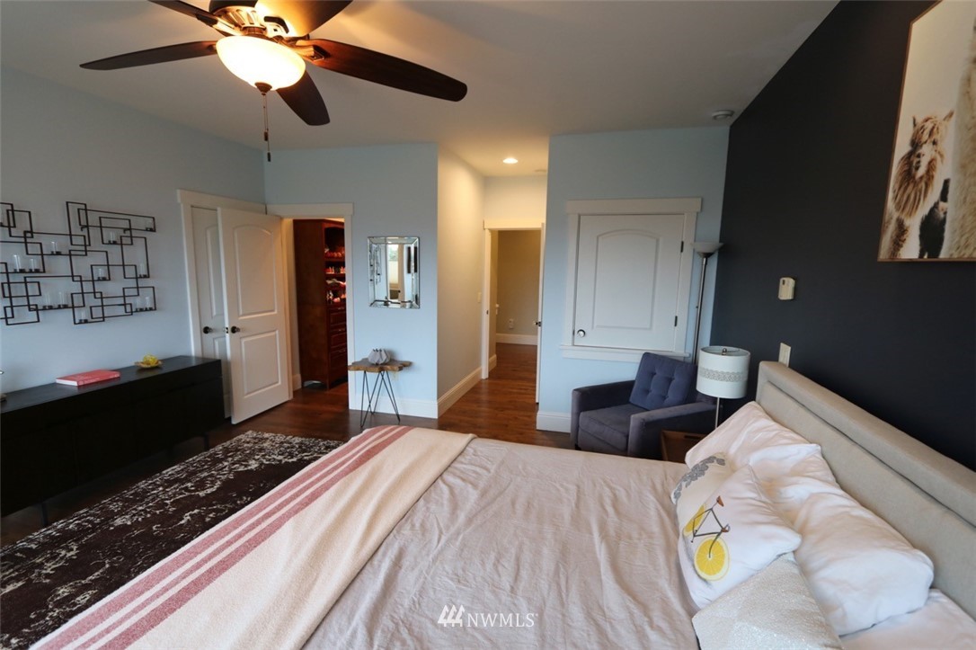 530 Briar Road Bellingham, WA 98225 - Photo 15 of 40 a bedroom with a bed and a chandelier