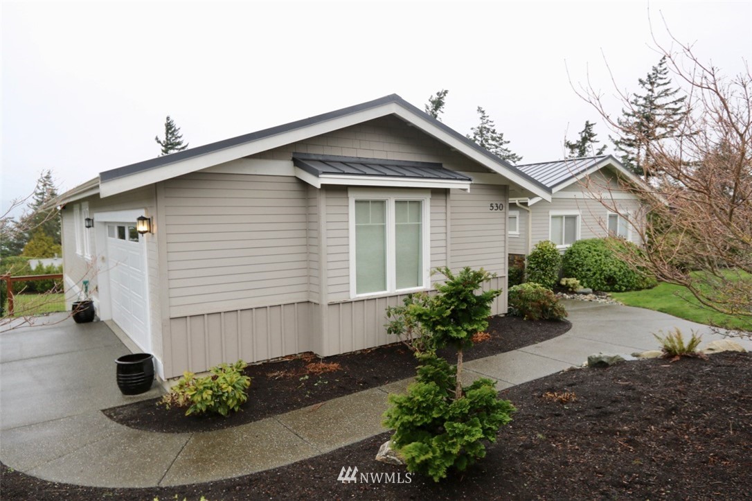 530 Briar Road Bellingham, WA 98225 - Photo 34 of 40 a white house with a yard and plants