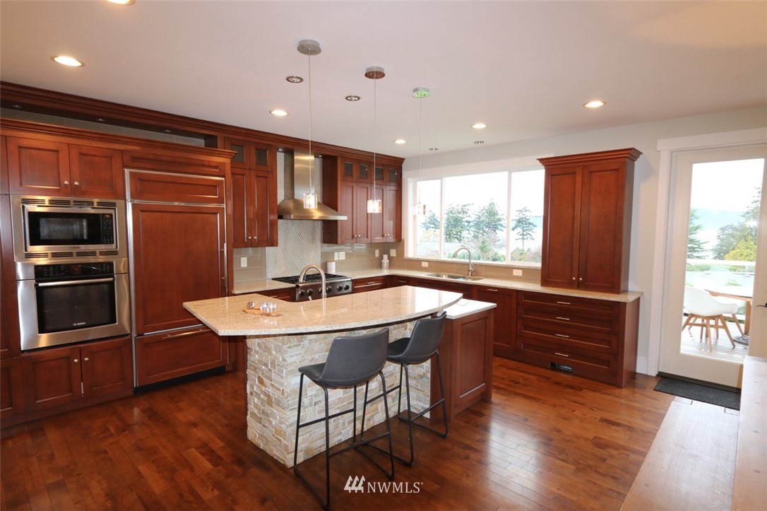 530 Briar Road Bellingham, WA 98225 - Photo 7 of 40 a kitchen with stainless steel appliances granite countertop a sink a stove a refrigerator and island with wooden floor