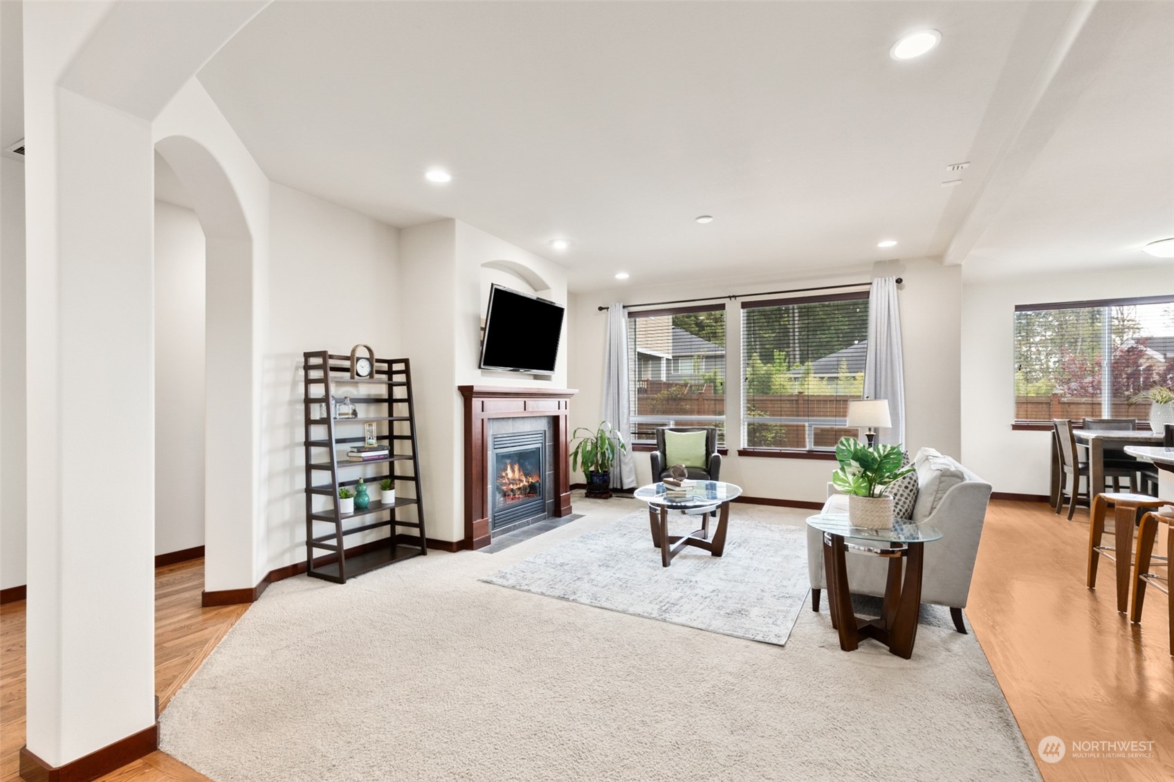 4114 222nd Place Southeast Bothell, WA 98021 - Photo 5 of 39 a living room with furniture a fireplace and a flat screen tv