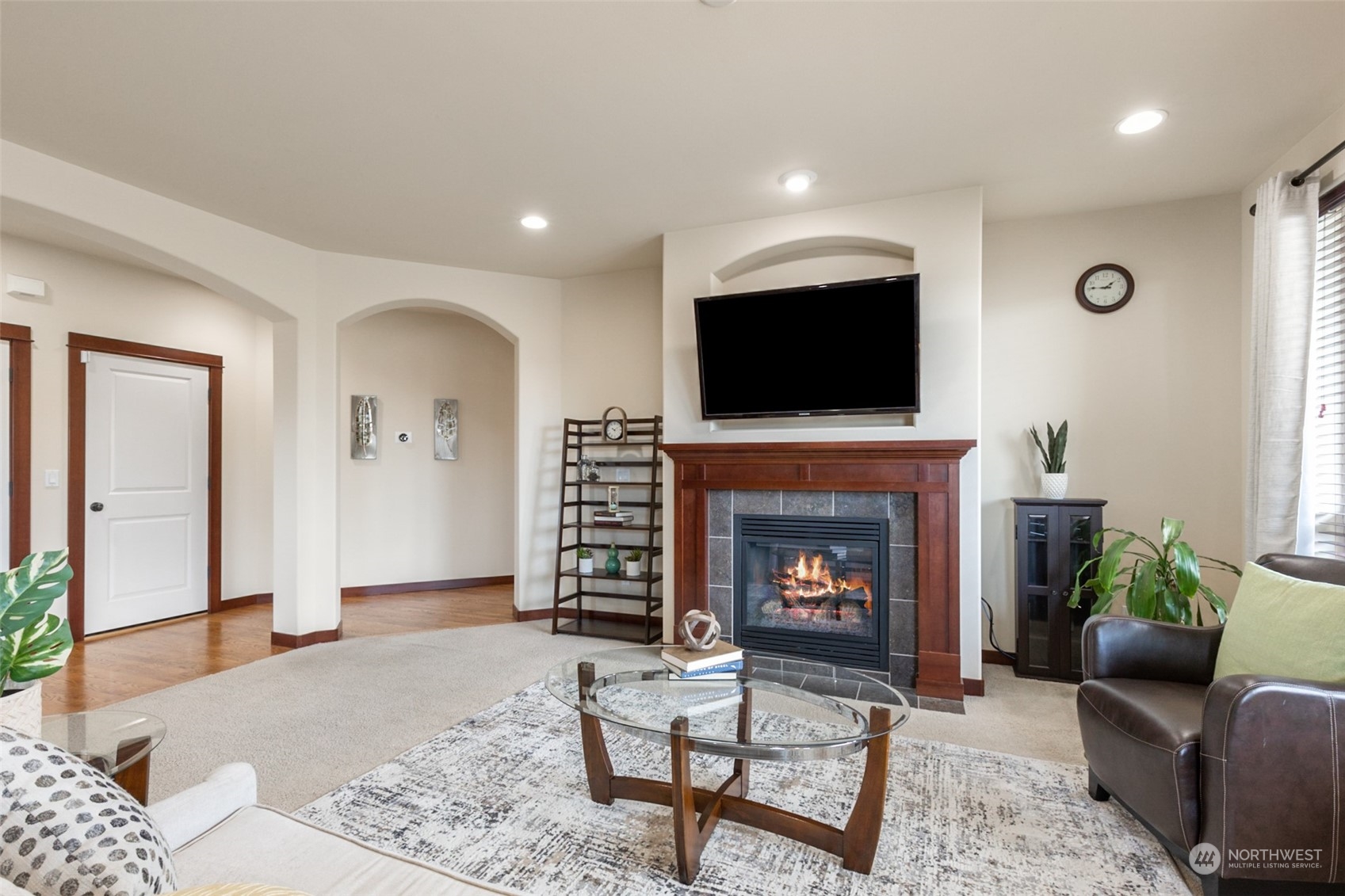 4114 222nd Place Southeast Bothell, WA 98021 - Photo 6 of 39 a living room with furniture a fireplace and a flat screen tv