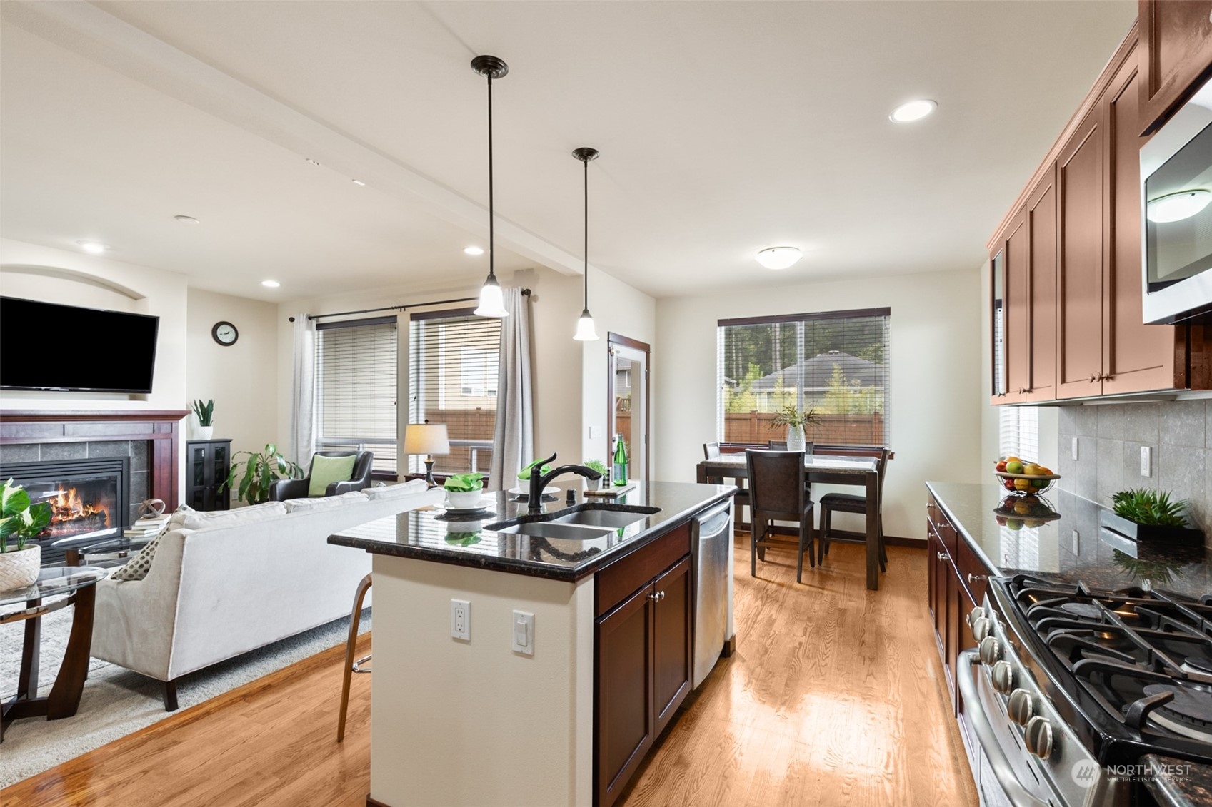 4114 222nd Place Southeast Bothell, WA 98021 - Photo 10 of 39 a kitchen with granite countertop a sink stove and cabinets