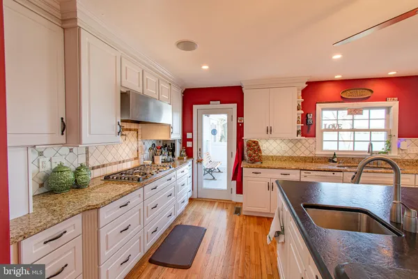 a kitchen with stainless steel appliances granite countertop a stove and a sink