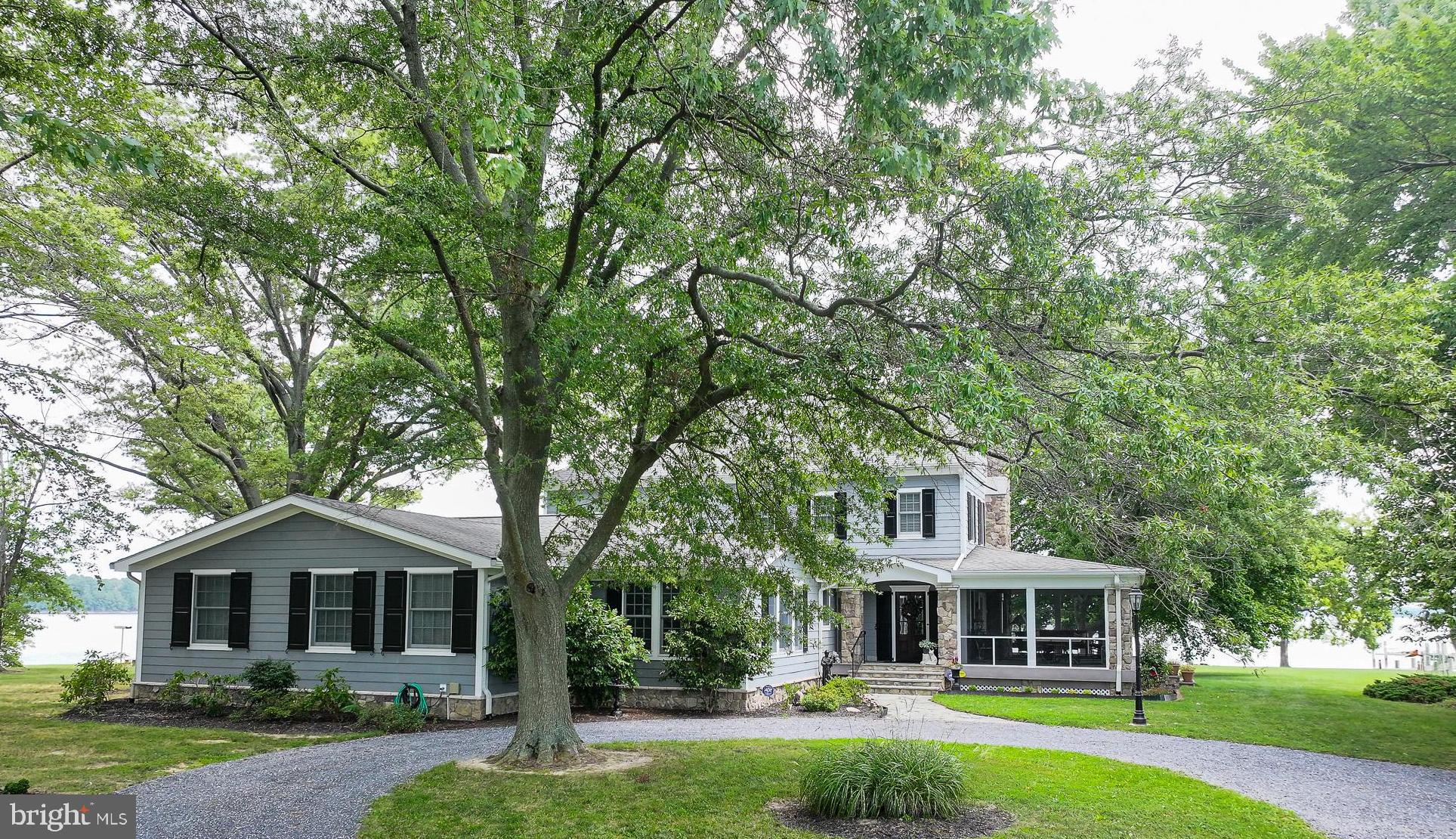 5995 Elston Shore Road Neavitt, MD 21652 - Photo 2 of 42 Charming lakeside retreat with lush greenery.