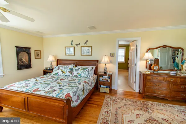 a bedroom with a large bed and a dresser