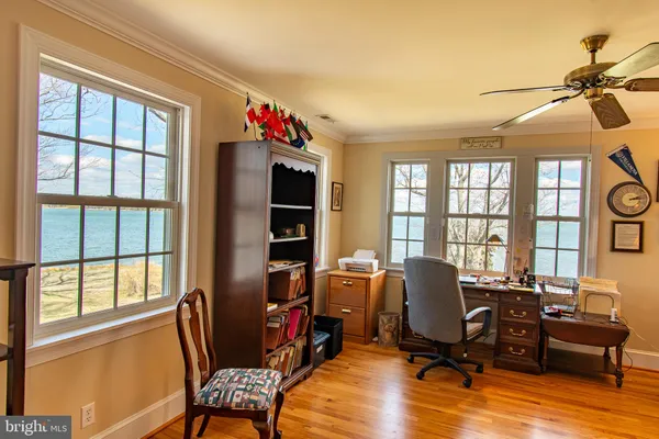 a view of a livingroom with workspace and a window