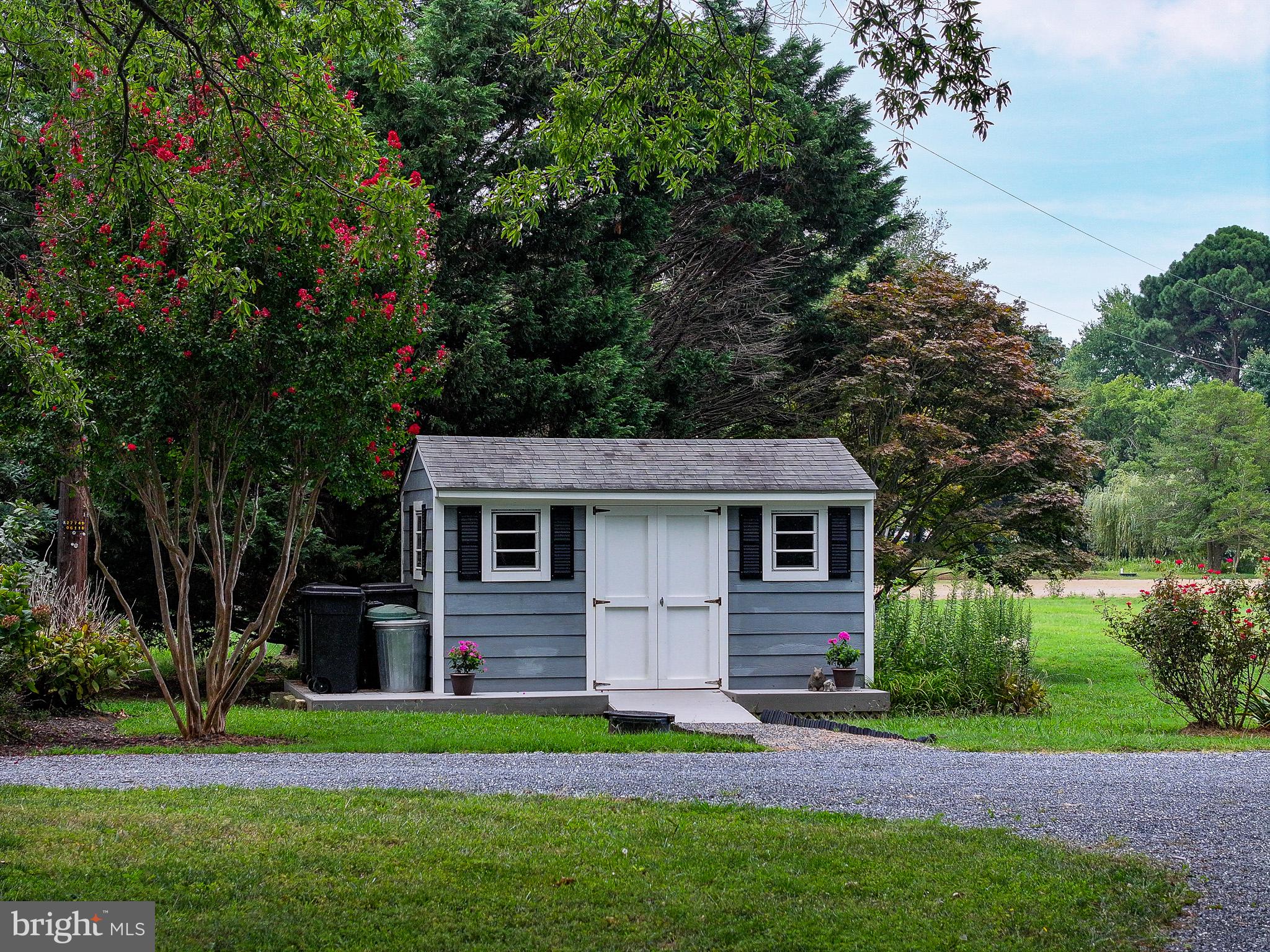 5995 Elston Shore Road Neavitt, MD 21652 - Photo 36 of 42 Charming garden shed in lush greenery.