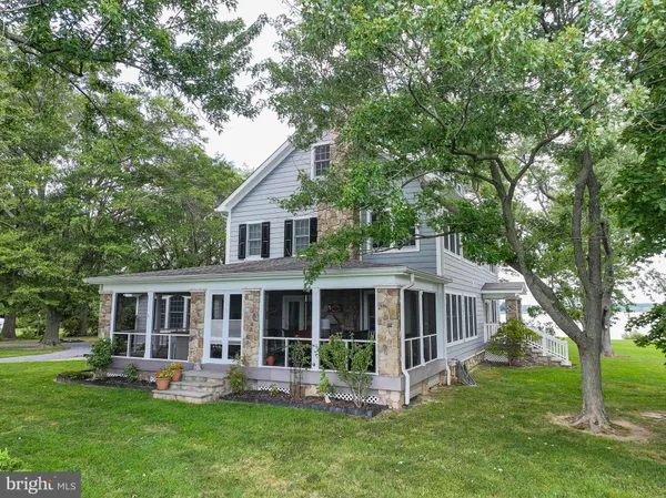 a view of a house with a yard and sitting area