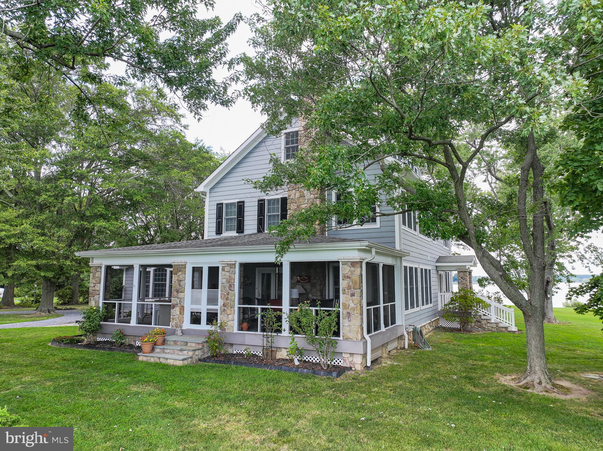 5995 Elston Shore Road Neavitt, MD 21652 - Photo 4 of 42 Charming lakeside retreat with lush greenery.