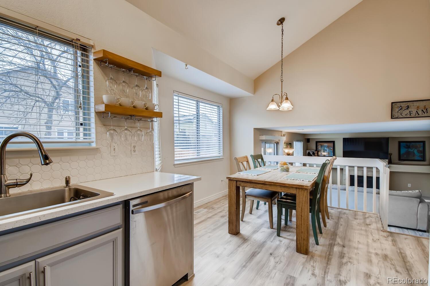 13173 Raritan Street Westminster, CO 80234 - Photo 8 of 28 a kitchen with granite countertop a sink a counter space and stainless steel appliances