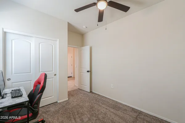 a view of a workspace with furniture and a window